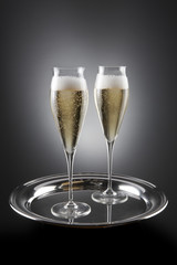 Two filled flutes of champagne