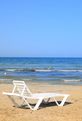 Fototapeta na wymiar deckchairs on the beach
