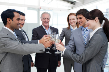 Cheerful business team toasting with Champagne