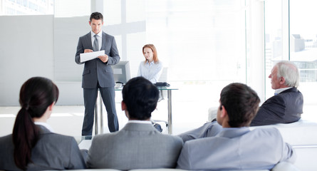 A teamleader talking to his colleagues