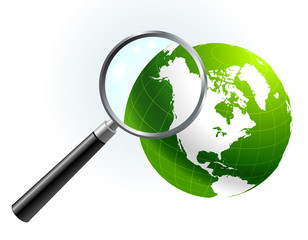 green globe under magnifying glass
