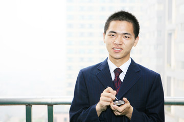 young asian businessman on the balcony