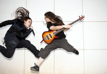 Two joung musician jumping