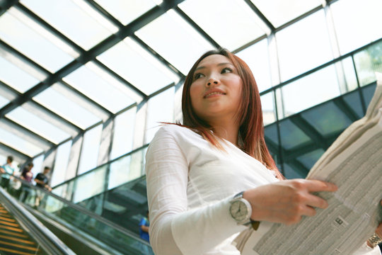 Young Asian Business Women Reading Newspaper