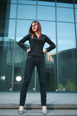 Obraz premium young asian businesswoman stand before office building