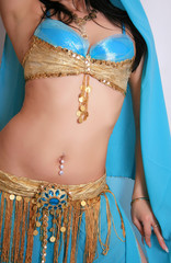 Beautiful belly dancer in blue outfit, isolated