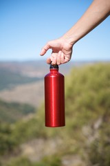 Obraz premium red bottle in hand