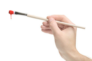 Hand holding a paint brush on white background