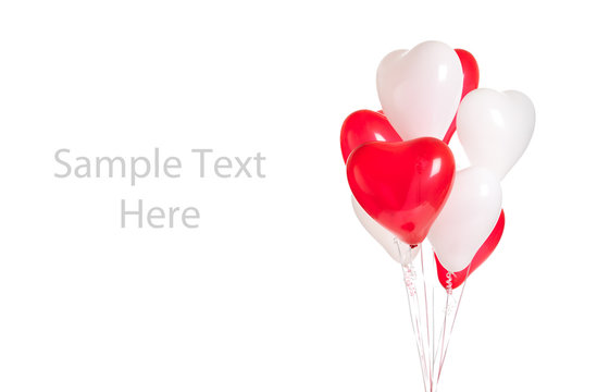 Assortment of heart balloons on white with copy space