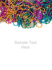 Mardi gras beads on white with copy space © Michael Flippo