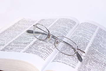 closeup of opened book and glasses