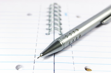 Metal mechanical pencil on a spiral-bound notepad