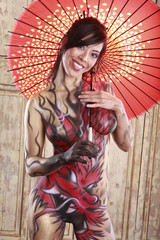 Dragon bodypainting asian girl with umbrella - obrazy, fototapety, plakaty