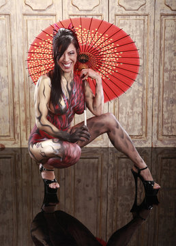 Dragon bodypainting asian girl with umbrella