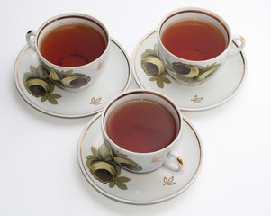 three cups of tea isolated on white.