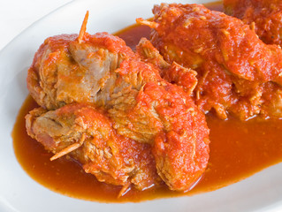 Meat roulade with tomato sauce on plate