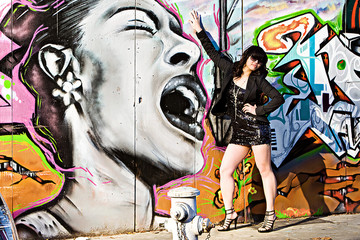 Asian woman next to shouting graffiti