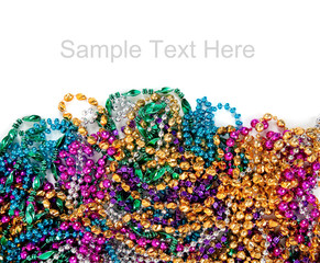 Mardi gras beads on white with copy space © Michael Flippo