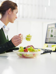 businesswoman eating salad
