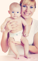 Young happy mother hugging baby