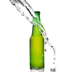 Green beer bottle with water splash isolated on white