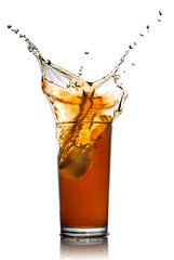 Beautiful splash of cola in glass isolated on white