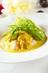 Asian dish with fish and vegetables close up