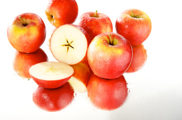 przekojone jabłko na lustrze, group of apples - obrazy, fototapety, plakaty