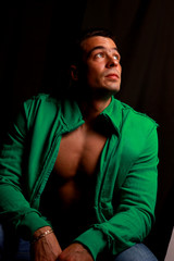 Obraz premium fashion male portrait on the floor over a black background.