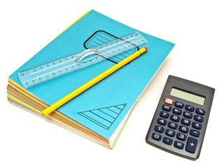 Notebooks stack, ruler and pencil near calculator