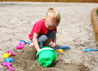 Little girl playing in the sand
