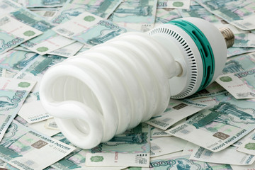 Power saving up bulb against the Russian money