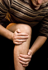 Young man having knee ache