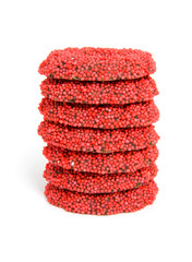 stacked red speckled christmas candy over white background