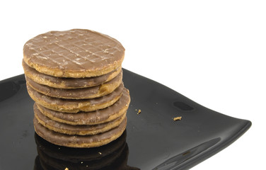 stack of chocolate biscuits / cookies on black plate