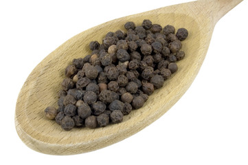 close in view of pepper corns on mixing spoon