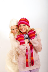 two young beautiful wonter woman in hat and gloves