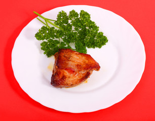 Roasted meat on a plate(Red background)