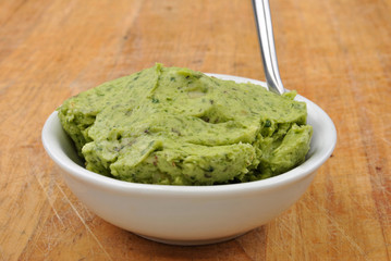 some organic fresh herb butter and a spoon