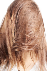 Naklejka premium chestnut natural long hair covering face of a woman