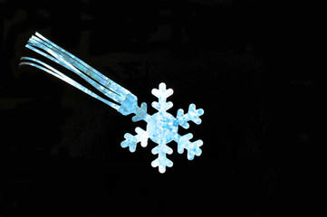 Isolated silver foil symbolizing a streamer or a flake on black