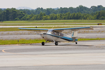 Blue and White Single Prop on Runway