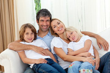Smiling family relaxing on the sofa