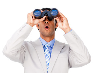 Surprised businessman looking through binoculars