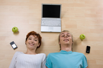 Couple with laptop and phones