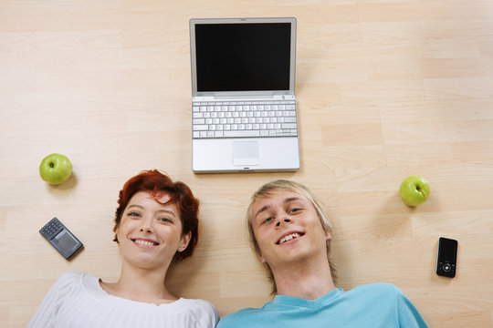 Couple with laptop and phones - Powered by Adobe