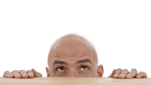 Mann schaut &uuml;ber Tischkante