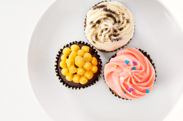 Delicious cupcakes isolated on white background