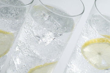 Glasses objects with soda water and ice cubes
