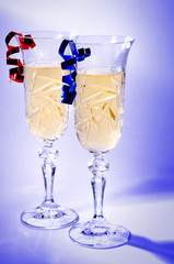 Pair of champagne glasses isolated on blue